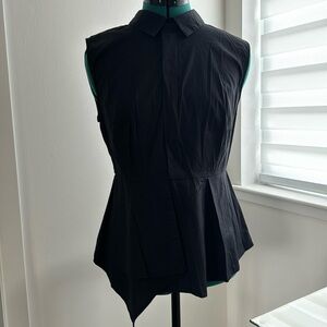 Flattering collared sleeveless cotton blend top with asymmetrical hem.